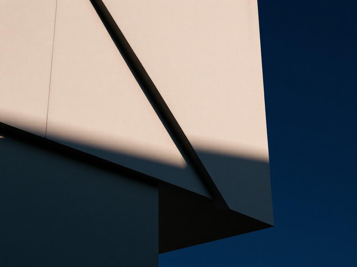 Modern concrete facade with sharp shadow line against deep navy sky